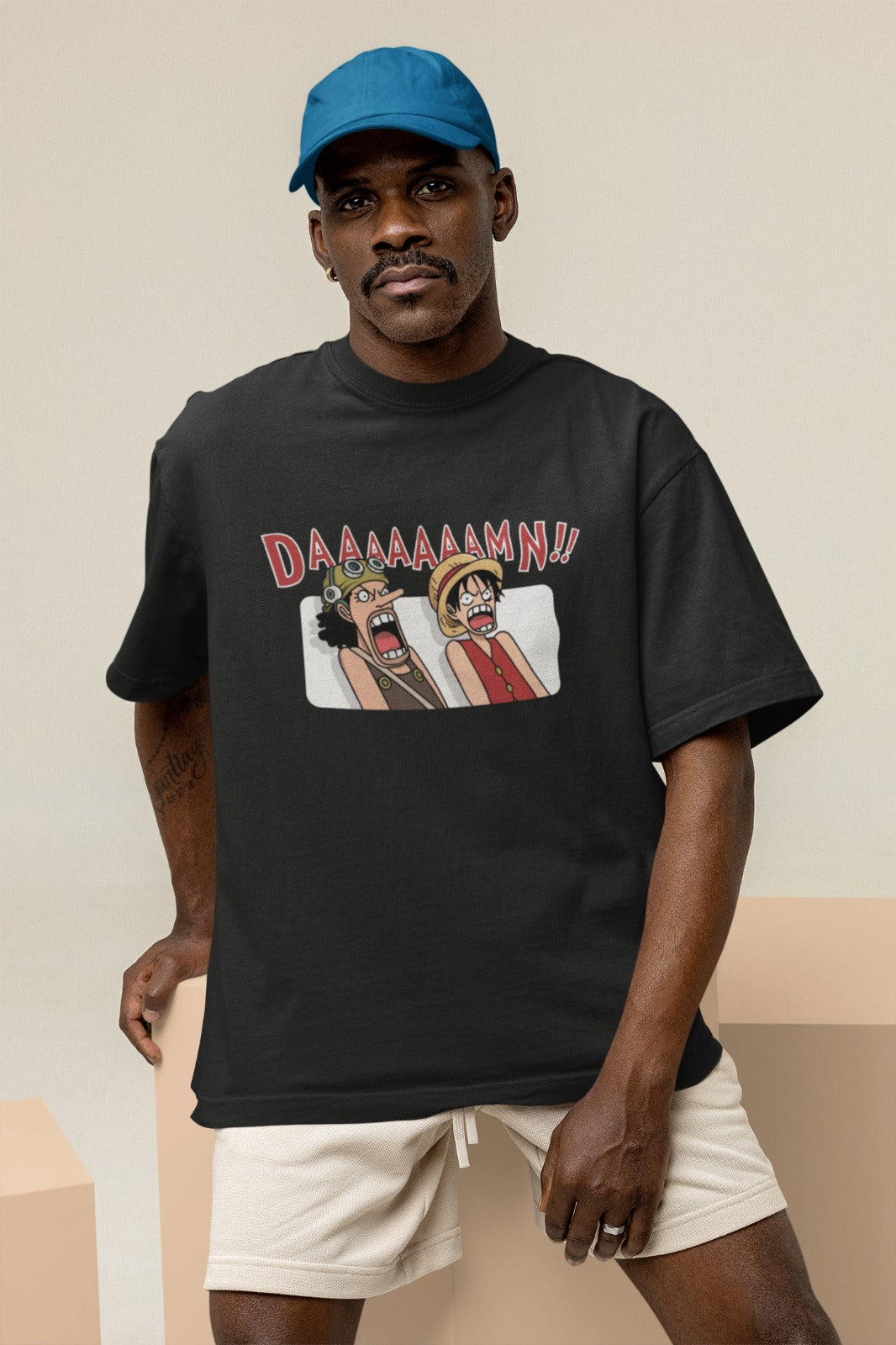 Embrace the humor of One Piece with our black unisex oversized t-shirt featuring a cartoonish Luffy and Usopp exclaiming "DAAAAAAAAMN!!" like in the movie. Crafted for style and comfort, this trendy tee is a must-have for anime fans. Express your love for the Straw Hat pirates and make a bold statement with this playful design today!