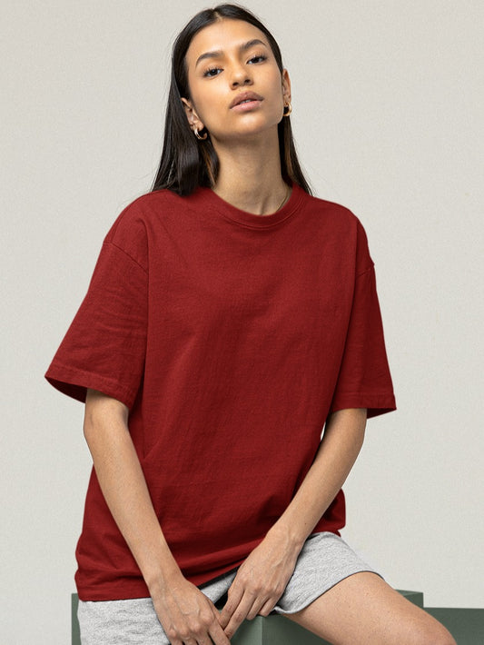 In this image, a young girl radiates casual elegance as she dons our Premium Heavyweight Maroon Oversized Tee. Its rich maroon hue contrasts beautifully with her grey shorts, creating a striking yet comfortable ensemble. The oversized tee drapes gracefully, embodying both comfort and style, while her relaxed confidence captures the essence of effortless chic.