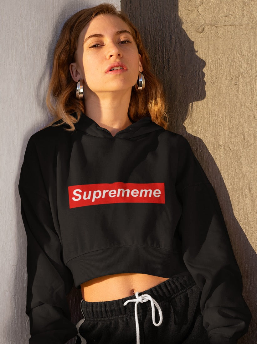 girl with huge round earrings wearing a black crop hoodie with suprememe printed on it in red colour