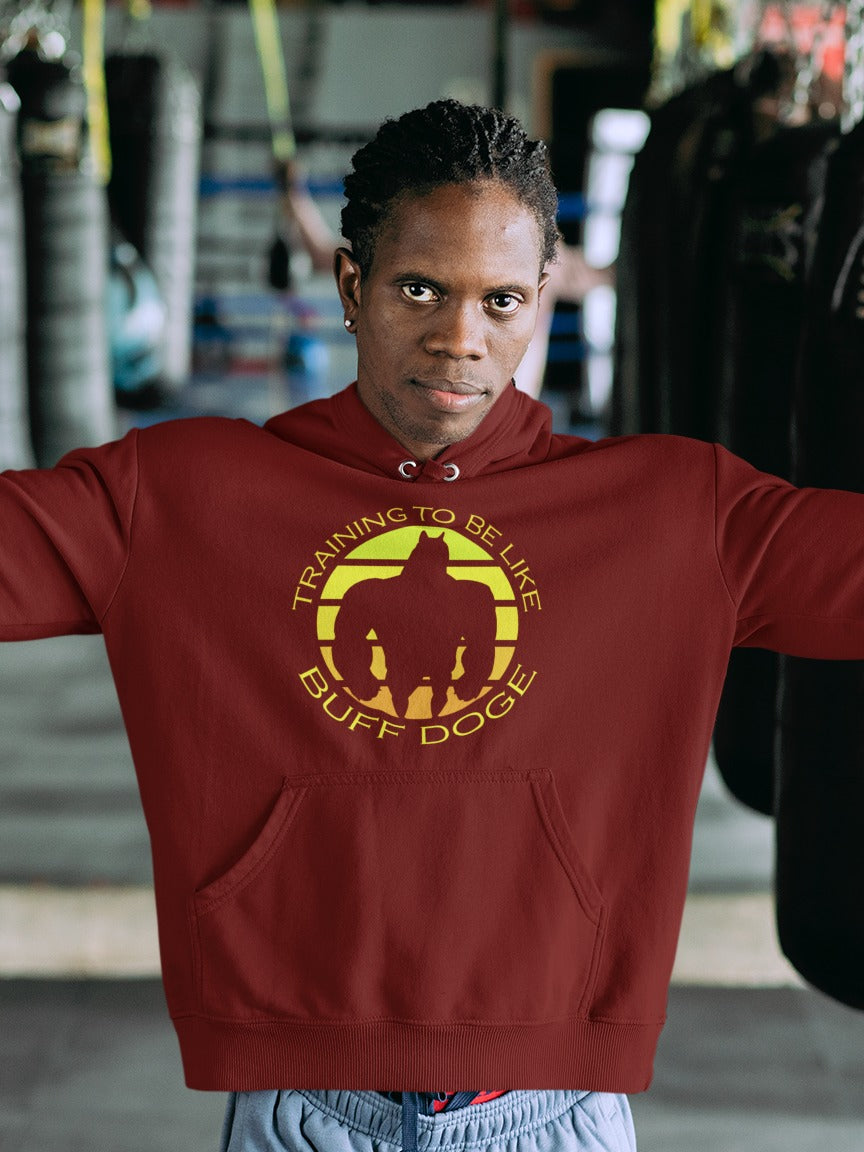 brown guy in a gym wearing a maroon hoodie with training to be like buff doge with silhouette go buffed up doge in the middle printed on it, gymming internet memes