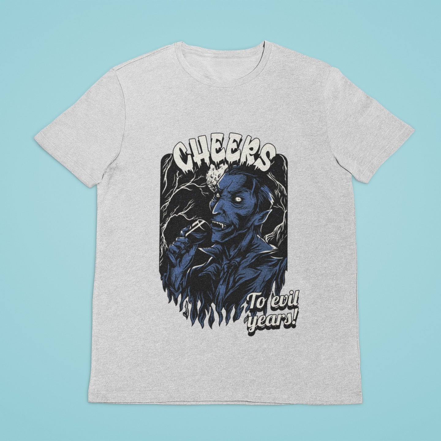 Raise your glass to the wicked with our grey t-shirt featuring the "Cheers to Evil Years" slogan and a graphic of a stylish vampire indulging in a sip from his wine glass. Perfect for Halloween or any gothic occasion, this tee is a must-have for all those who love to embrace their darker side. Get yours now and toast to the spooky season in style!