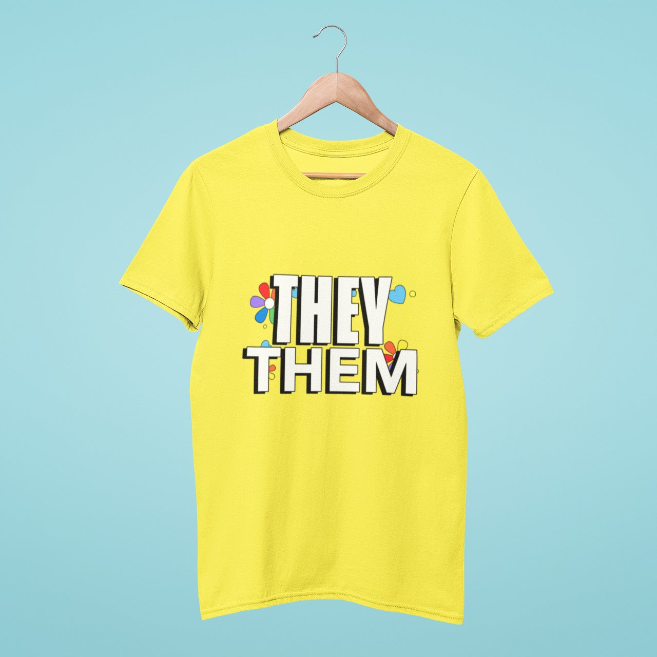 Our yellow round neck t-shirt features a 'They Them' design with rainbow flowers in the background, making it the perfect way to show your support for gender-neutral pronouns. Available in various sizes and made with high-quality materials, order now to add a touch of positivity and inclusivity to your wardrobe.