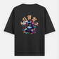 A pixelated cat wearing headphones and sunglasses plays a video game with a controller. The image features the text "GAM Oversized T-shirt (Back print) by @ktart31
