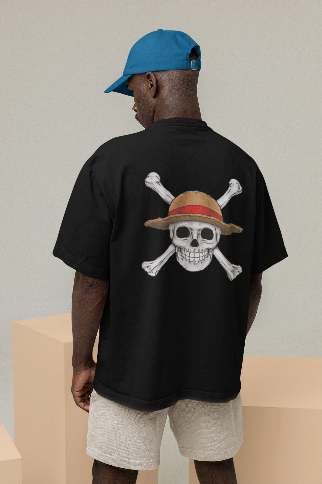 Elevate your anime style with our black oversized t-shirt featuring One Piece's Straw Hat Pirate Crew Jolly Roger design. This trendy tee showcases a realistic skull Jolly Roger on the back and a cartoonish version on the front. Made with high-quality materials, it's perfect for casual outings or anime conventions. Make a bold fashion statement and sail with the Straw Hat Pirates today!