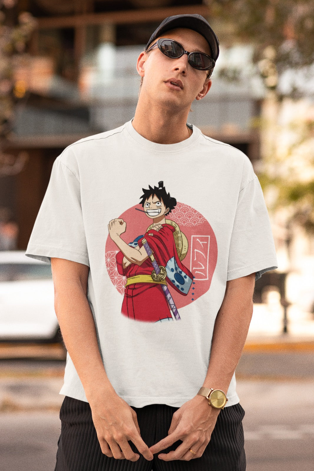Embrace Luffy's Wano arc style with our white unisex oversized t-shirt. This captivating design features him wearing the iconic kimono, showcasing his adventurous spirit. With his name beautifully written in Japanese as a background detail, the tee blends authenticity and style. Crafted with premium quality materials, it's a must-have for anime enthusiasts. Elevate your wardrobe and embrace the spirit of adventure with this unique t-shirt today!