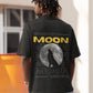 Elevate your style with our Premium Black Oversized T-Shirt, featuring a captivating graphic design on the back: a full moon, a howling wolf silhouette, and the bold word MOON. Above, a poetic message reads, "Beneath the silver moonlight, the lone wolf let out a haunting howl that echoed through the forest." Below, "Its voice carried the weight of ancient wisdom and untamed freedom, captivating all who heard it." Crafted meticulously, Order now and let your inner wolf howl with style.
