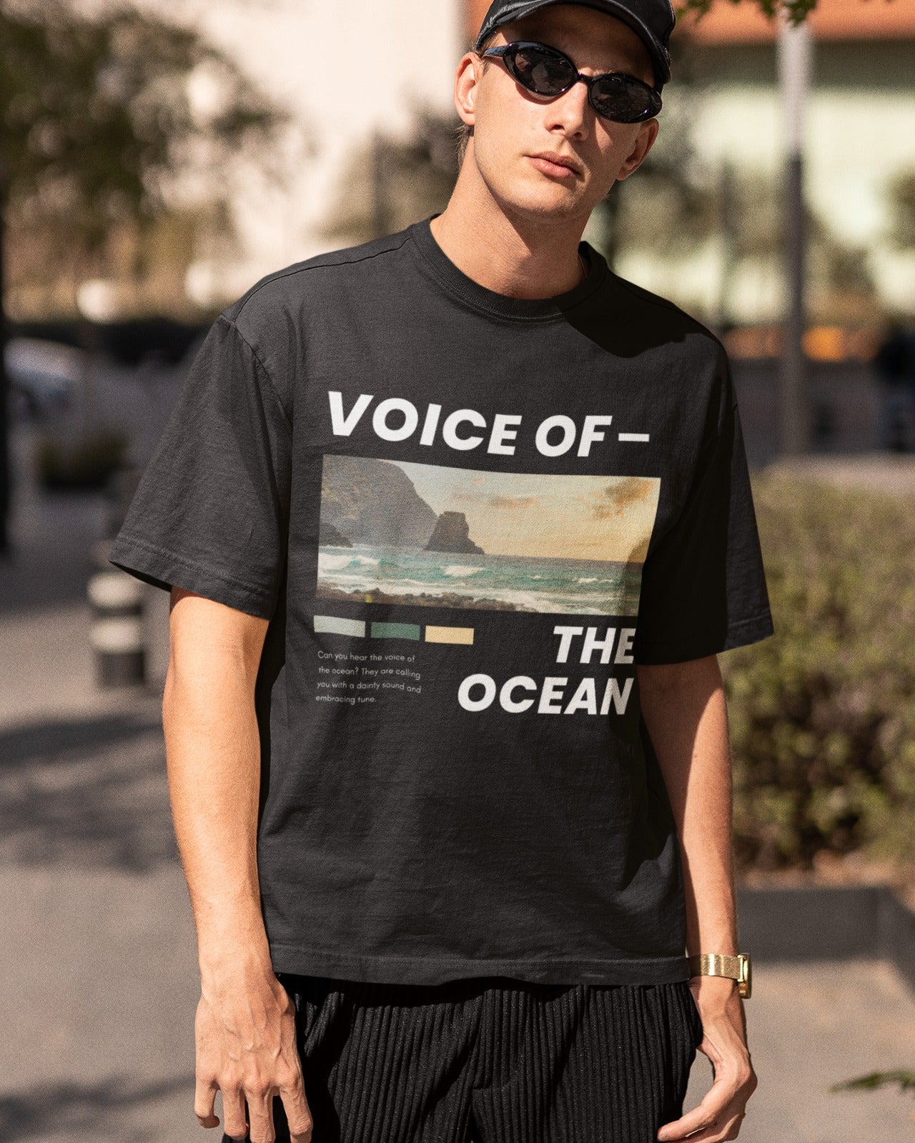 Embrace nature's beauty with our oversized black t-shirt. Featuring a serene beach and mountain view, it showcases the title "VOICE OF - THE OCEAN" to celebrate the ocean's power. Poetic words beneath read, "Can you hear the voice of the ocean? They are calling you with a dainty sound and embracing tune," creating a harmonious connection with nature. Crafted with premium materials, this t-shirt offers both comfort and style, expressing your love for the ocean's enchanting melody.