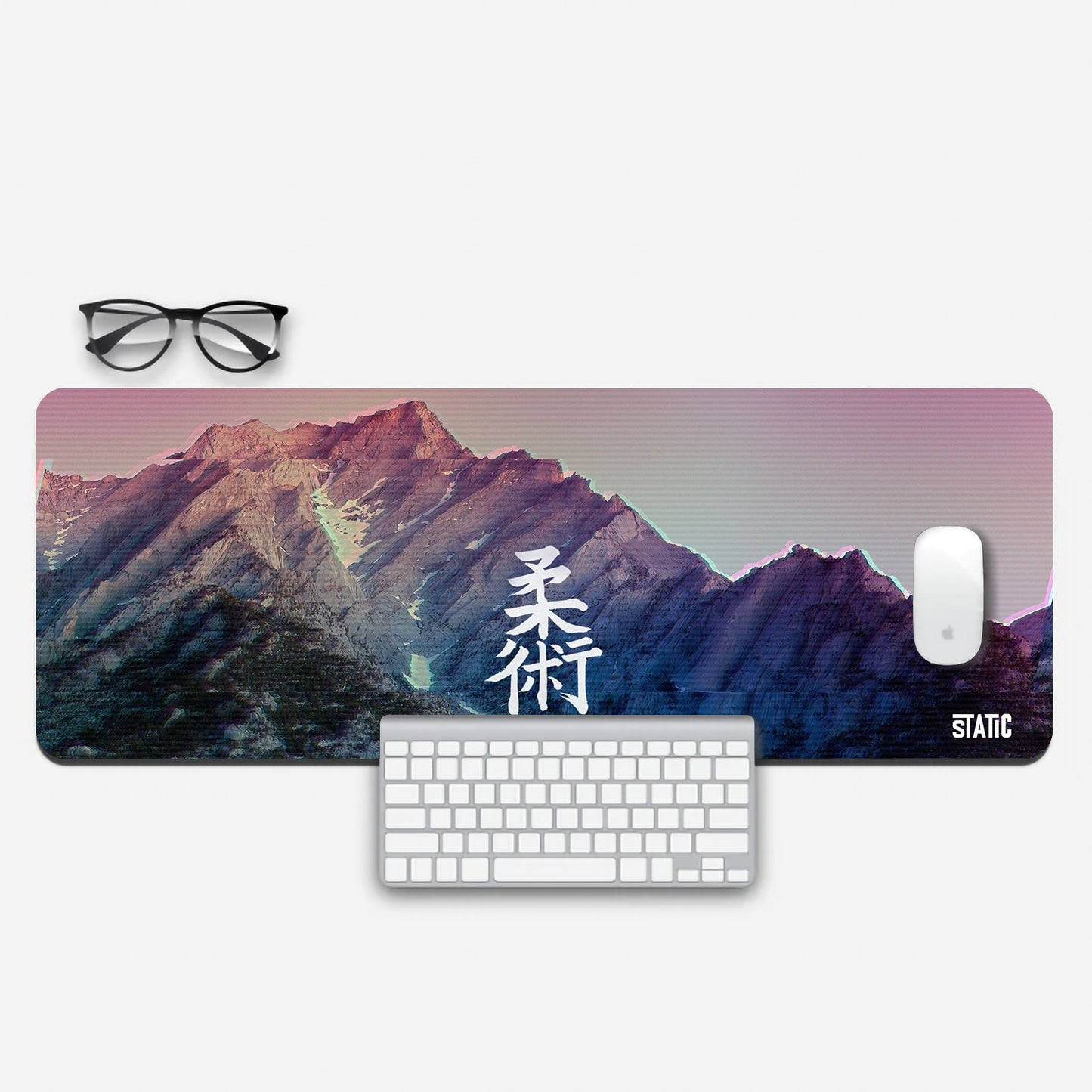 Elevate your gaming with our Jutsu-Ban Extended Gaming Mouse Pad. Immerse yourself in a snowy mountain vista with captivating purple and green hues, enhanced by a TV haze effect. Bold Japanese characters "Jutsu-Ban" add authenticity to your setup. This pad combines style and precision, taking your gaming to new heights. Upgrade today for a gaming experience that's both immersive and aesthetically pleasing.