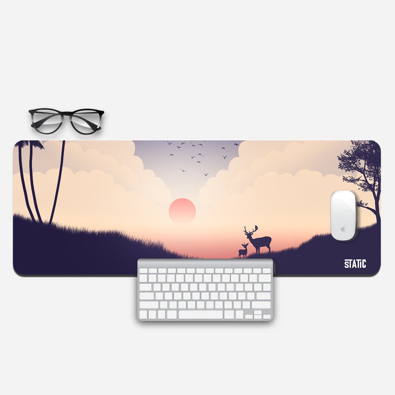 Transform your gaming space with our extended mouse pad – Enchanted Forest Edition. Immerse yourself in a captivating scene featuring the silhouettes of a majestic deer and its fawn against a backdrop of a radiant red sun rising above the fog-covered landscape. Birds take flight, and clouds encircle the sun, creating an ethereal ambiance. Elevate your gaming experience and workspace aesthetics with this enchanting mouse pad. Order now and journey into the beauty of the enchanted forest.