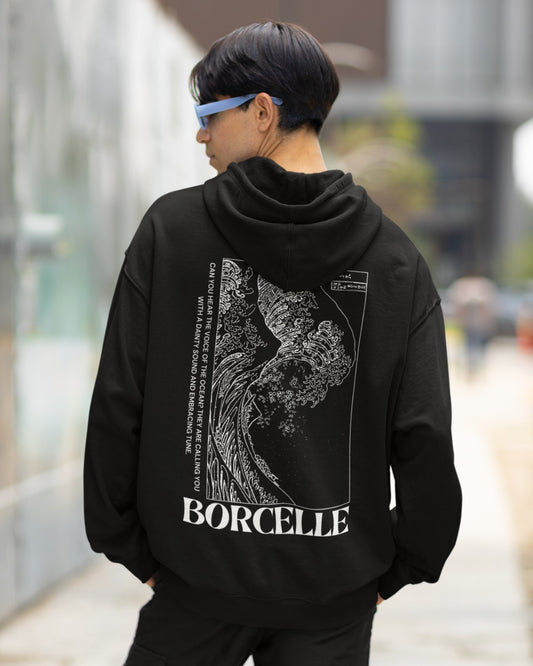 Elevate your style with our Black Oversized Hoodie featuring a striking Japanese-style white wave on the back. Titled "BORCELLE" in bold at the bottom, this shirt adds artistic flair to your wardrobe. The poetic caption, "Can you hear the voice of the ocean? They are calling you with a dainty sound and endearing tune," enhances its charm. Crafted with precision, it's not just a hoodie; it's wearable art. Make a statement today and embrace the ocean's allure in style.