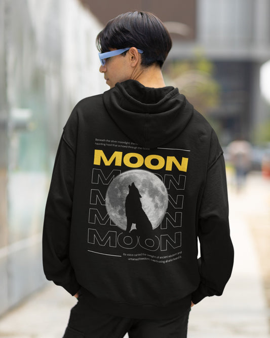 Unleash your inner wild with our Black Oversized Hoodie. Featuring a captivating moonlit design, a howling wolf silhouette embodies untamed freedom. "MOON" stands boldly in yellow, channeling ancient wisdom. This hoodie is not just clothing; it's an expression of your wild spirit. Embrace the call of the night with this stylish statement piece.