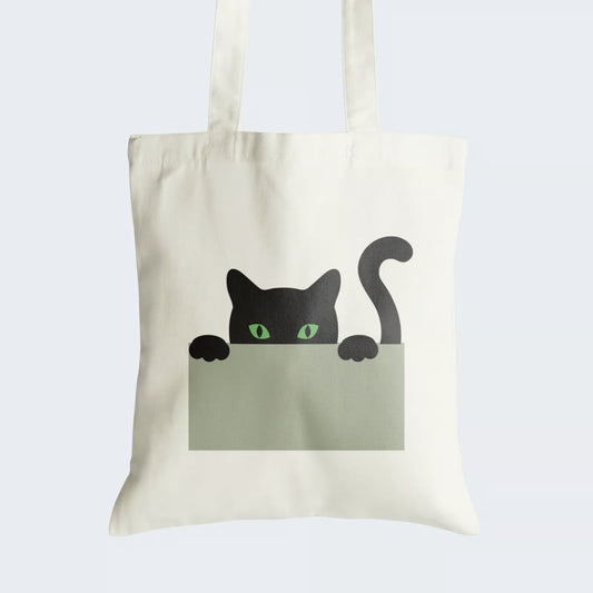 Elevate your style and embrace the allure of feline intrigue with our "Mystery Cat" Cotton Canvas Tote Bag. This chic tote features a minimalist black cat with mesmerizing green eyes, playfully peering from behind a sleek grey wall. Crafted for both durability and style, it includes a secure zipper closure for daily convenience. Express your love for cats with this fashionable and enigmatic Cotton Canvas Tote Bag. Order yours today and add a touch of mystery to your ensemble!