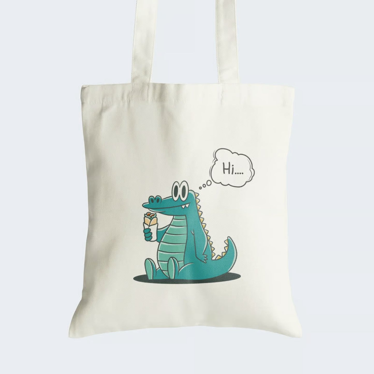 Elevate your style with our "Hi There Crocodile" Cotton Canvas Tote Bag, a delightful blend of charm and whimsy. This tote showcases an endearing image of a cute crocodile sitting on its back legs, relishing a roll, and offering a friendly "Hi..." message in a cloud above. Crafted for durability and style, it includes a secure zipper closure for daily convenience. Carry the joy of this adorable crocodile with our fashionable Cotton Canvas Tote Bag. Order yours today and spread smiles wherever you go!