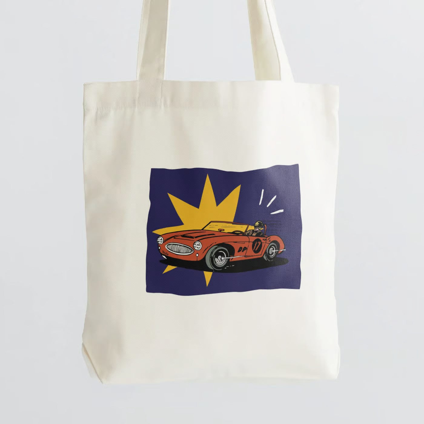 Evoke the spirit of classic automotive style with our "Retro Roadster" Cotton Canvas Tote Bag. This tote features a vintage racing car, top-down, capturing the essence of open-road adventure and timeless design. Crafted for durability and style, it includes a secure zipper closure for daily convenience. Whether you're an auto enthusiast or a lover of classic aesthetics, our Cotton Canvas Tote Bag is the perfect accessory to showcase your passion. Order yours today and ride in style!