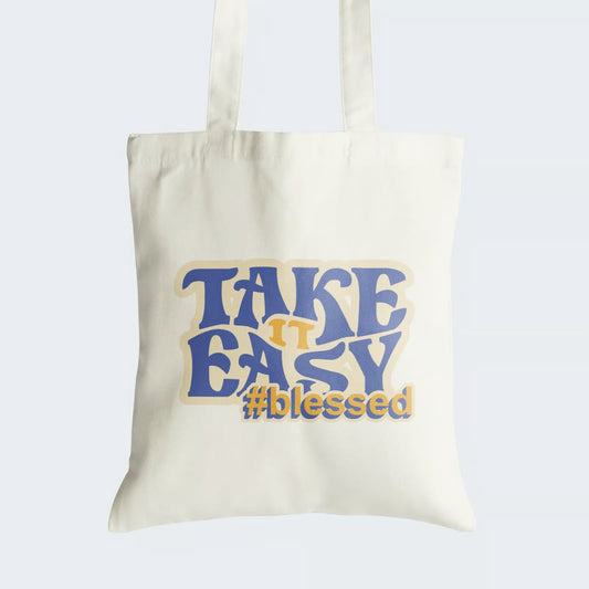 Elevate your style and embrace a positive mindset with our "Take It Easy #Blessed" Cotton Canvas Tote Bag. This tote features an encouraging message in stylish text, reminding us to appreciate life's blessings and find tranquility in simplicity. Crafted for durability and style, it includes a secure zipper closure for daily convenience. Carry the message of gratitude and positivity with our fashionable Cotton Canvas Tote Bag. Order yours today and stay #Blessed in style!