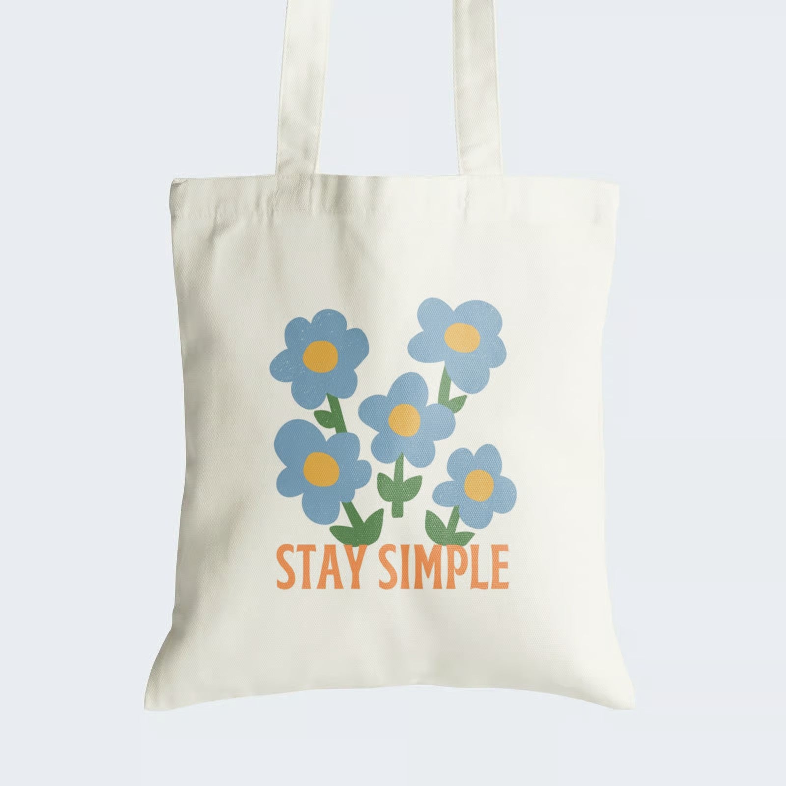 Elevate your style with our "Stay Simple" Cotton Canvas Tote Bag, an ode to the beauty of simplicity. This tote features a graphic design of five delicate blue flowers, symbolizing natural elegance, along with the caption "Stay Simple." Crafted for durability and style, it includes a secure zipper closure for daily convenience. Carry the message of uncomplicated charm and the allure of simplicity with our stylish Cotton Canvas Tote Bag. Order yours today and embrace the grace of simplicity!