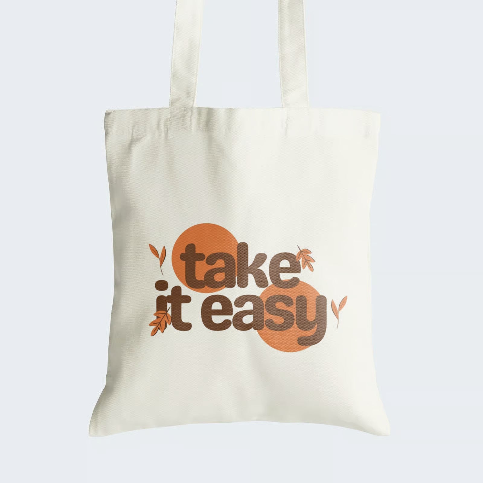 Elevate your style and find tranquility with our "Take It Easy" Cotton Canvas Tote Bag. This tote features a calming graphic text message, "Take It Easy," surrounded by graceful autumn leaves, evoking the serene beauty of the season. Crafted for both durability and style, it includes a secure zipper closure for daily convenience. Carry the message of relaxation and embrace autumn's serenity with our stylish Cotton Canvas Tote Bag. Order yours today!