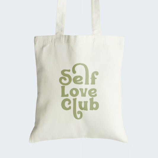 Elevate your style and self-esteem with our "Self Love Club" Cotton Canvas Tote Bag. This tote showcases an aesthetic graphic text in lush green, reading "Self Love Club," serving as a daily reminder of self-care and self-appreciation. Crafted for both durability and style, it features a secure zipper closure for daily convenience. Make a statement and empower yourself with our "Self Love Club" Cotton Canvas Tote Bag. Order yours today and carry self-love wherever you go!