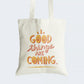 Elevate your style and embrace optimism with our "GOOD things ARE COMING" Cotton Canvas Tote Bag. This tote features a unique graphic text design where the O's in "GOOD" and "COMING" are replaced by cheerful smileys, radiating positivity. Crafted for durability and style, it includes a secure zipper closure for everyday convenience. Carry this reminder of hope and optimism with our "GOOD things ARE COMING" Cotton Canvas Tote Bag. Order yours today and stay positive!