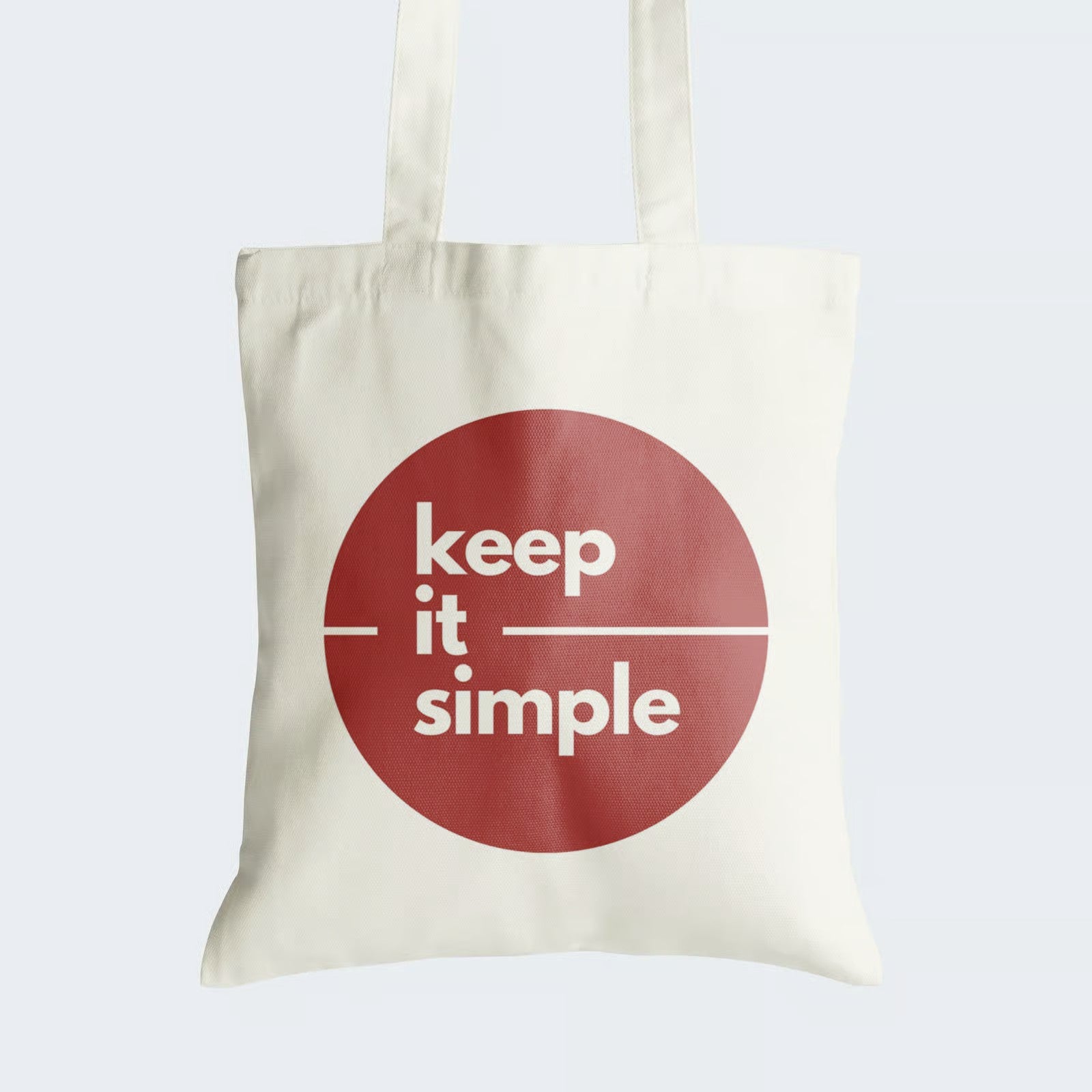 Elevate your style with our Cotton Canvas Tote Bag, featuring a maroon circle housing the timeless message "Keep it Simple." Crafted for both durability and elegance, this tote boasts a secure zipper closure for everyday convenience. By choosing this reusable bag, you embrace the beauty of simplicity while making a fashionable statement. Elevate your accessory collection with our "Keep it Simple" Cotton Canvas Tote Bag - order now to carry simplicity in style!