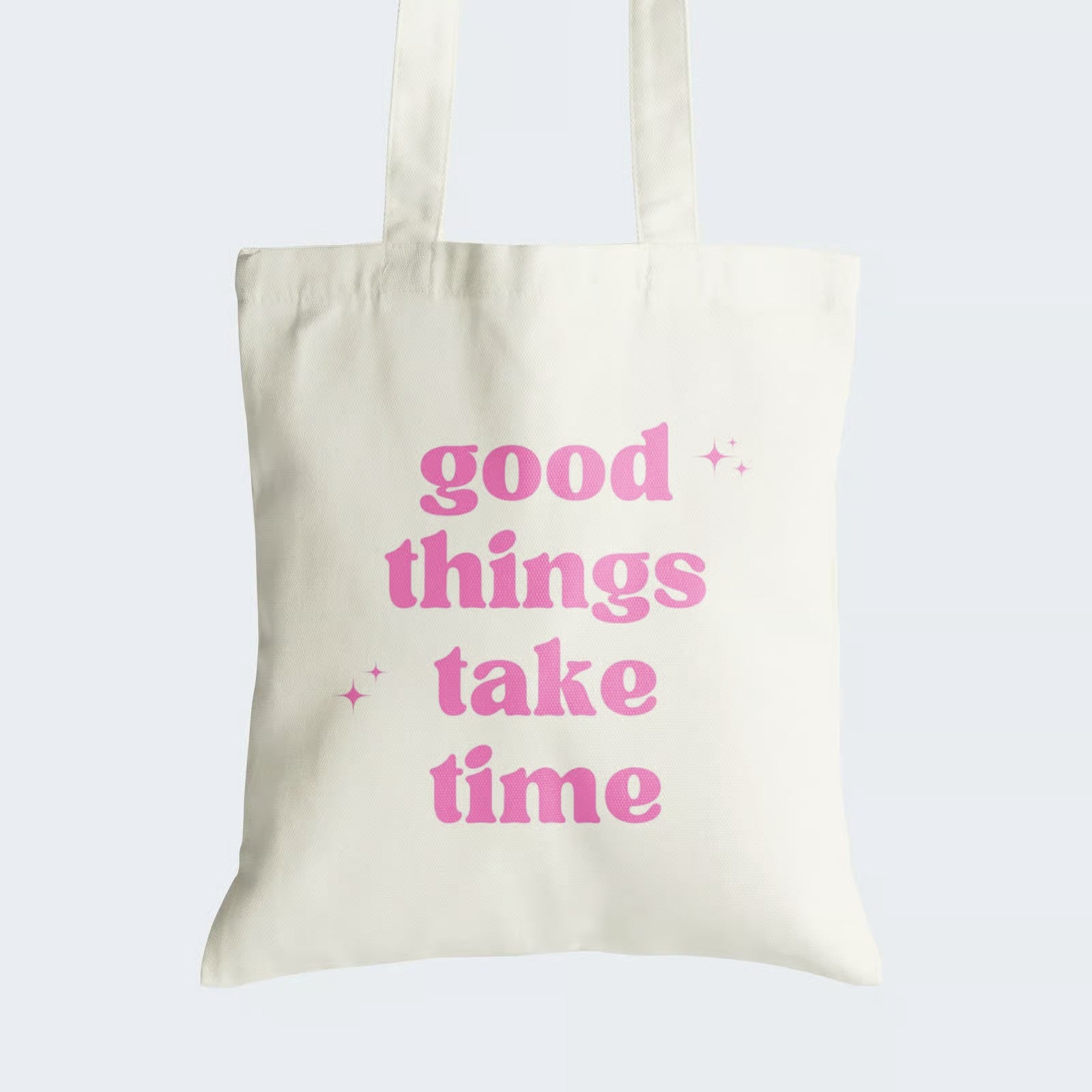 Elevate your style and patience with our Cotton Canvas Tote Bag. Boldly featuring the graphic text "Good Things Take Time" in vibrant pink, this tote is a fashionable reminder of life's wisdom. Crafted for both durability and style, it includes a secure zipper closure for daily convenience. By choosing this reusable tote, you celebrate patience and sustainability in one chic package. Get yours today and carry a touch of wisdom with you!