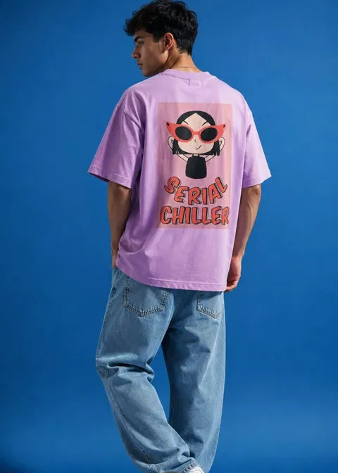 Person wearing a pink t-shirt with a graphic design and text on the back against a blue background