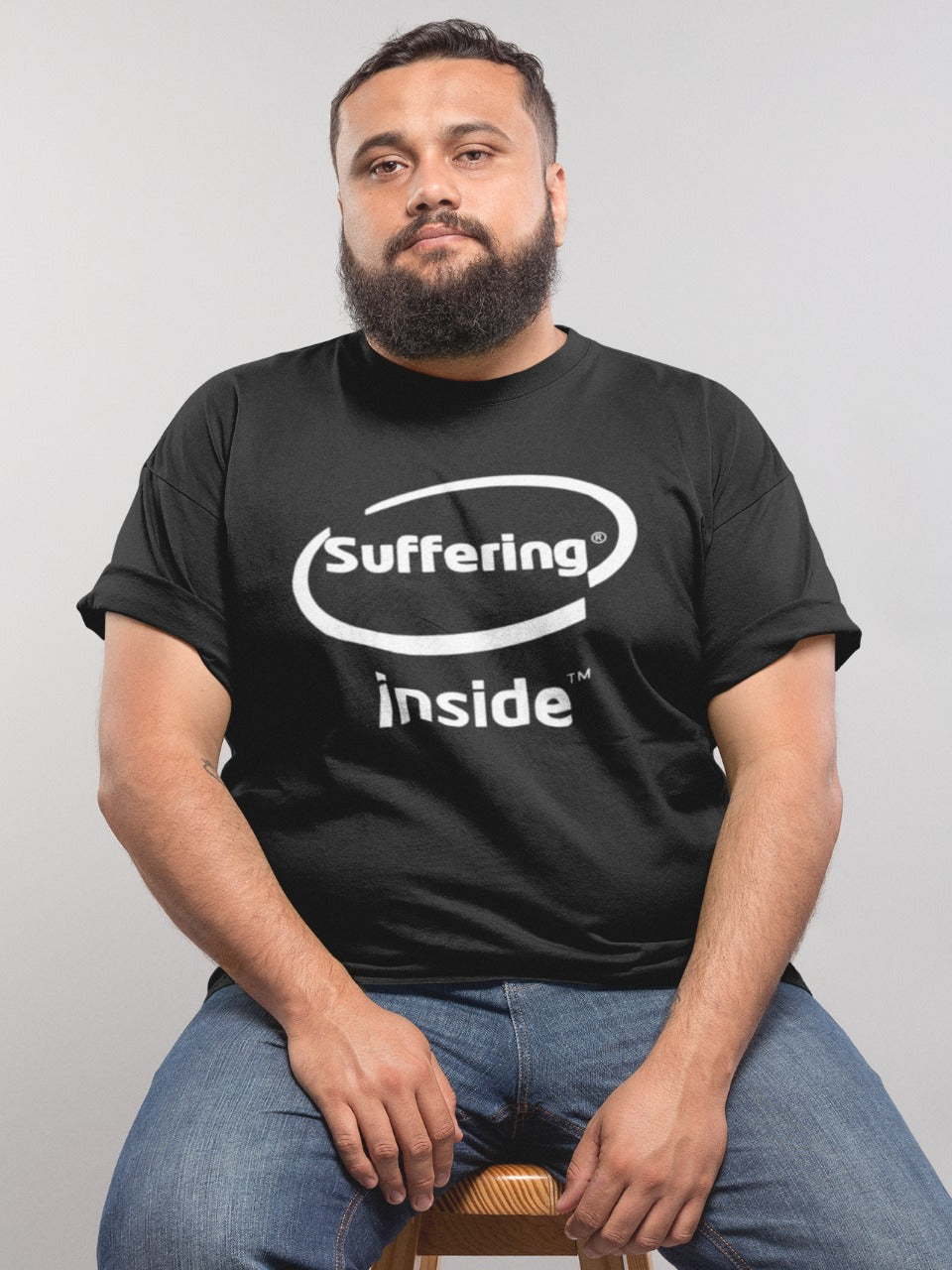 Add some humor to your wardrobe with our picture of a fun-loving guy wearing our black "Suffering Inside" t-shirt. Featuring a graphic design inspired by the popular meme and Intel Inside logo, this edgy shirt is perfect for making a statement and showing off your love for internet culture. Order now and join the trendsetting meme enthusiasts!