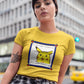girl with cropped hair and moth tattoo on right hand wearing a yellow crop top with console style picture of surprised pikachu with the message "Life uses confusion, It's super effective" printed on it