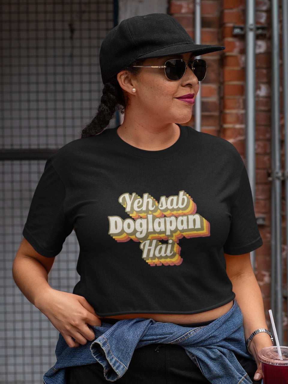 woman wearing a cap and black shades with a black croptop with yeh sab doglapan hai printed on it, shark tank india memes