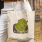 woman holding a canvas tote bag with picture of Shrek asking "is that legal?" printed on it, environmental memes