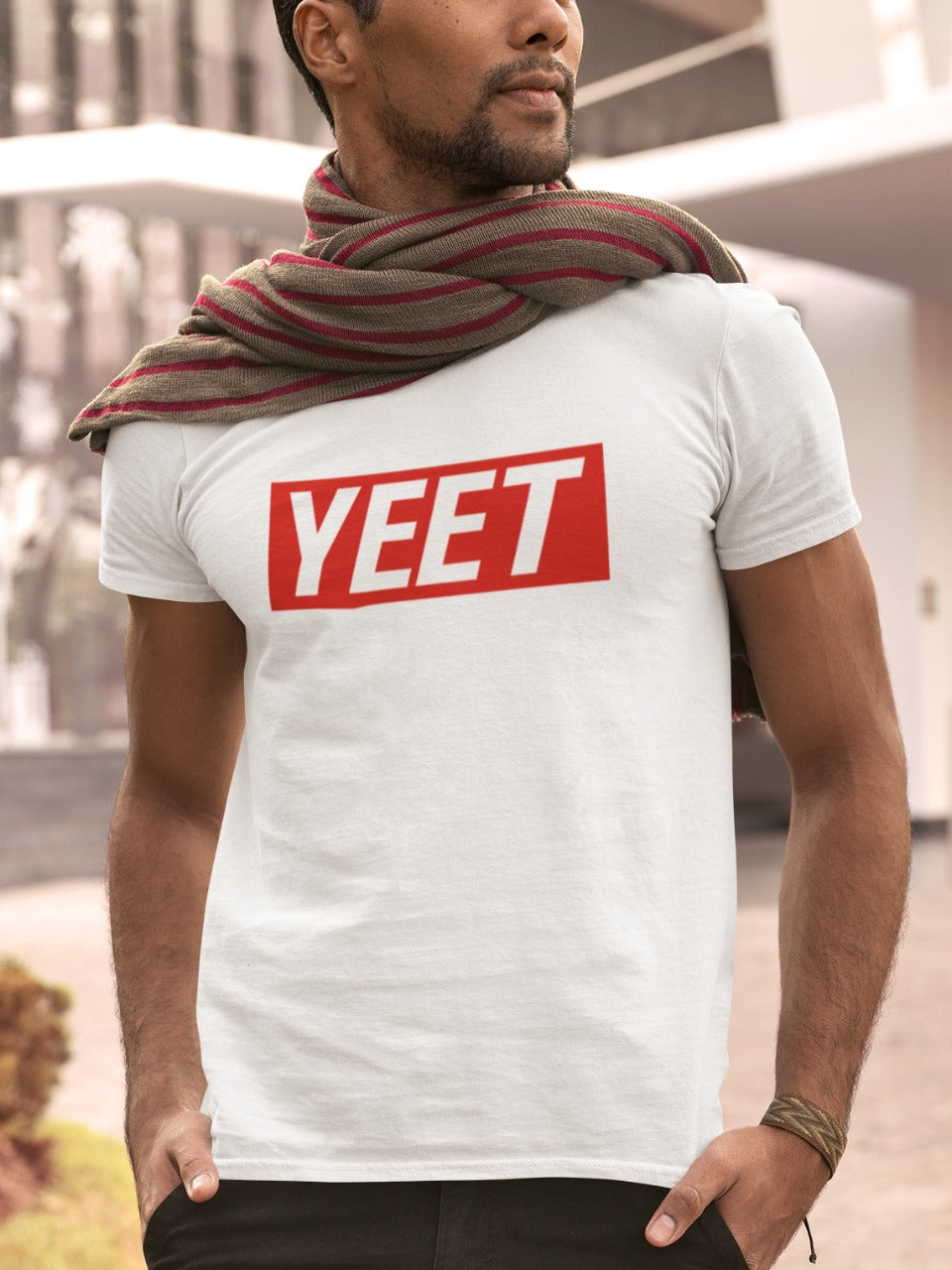 Man with light beard wearing a scarf and white tshirt with yeet written on it in red colour, cool memes