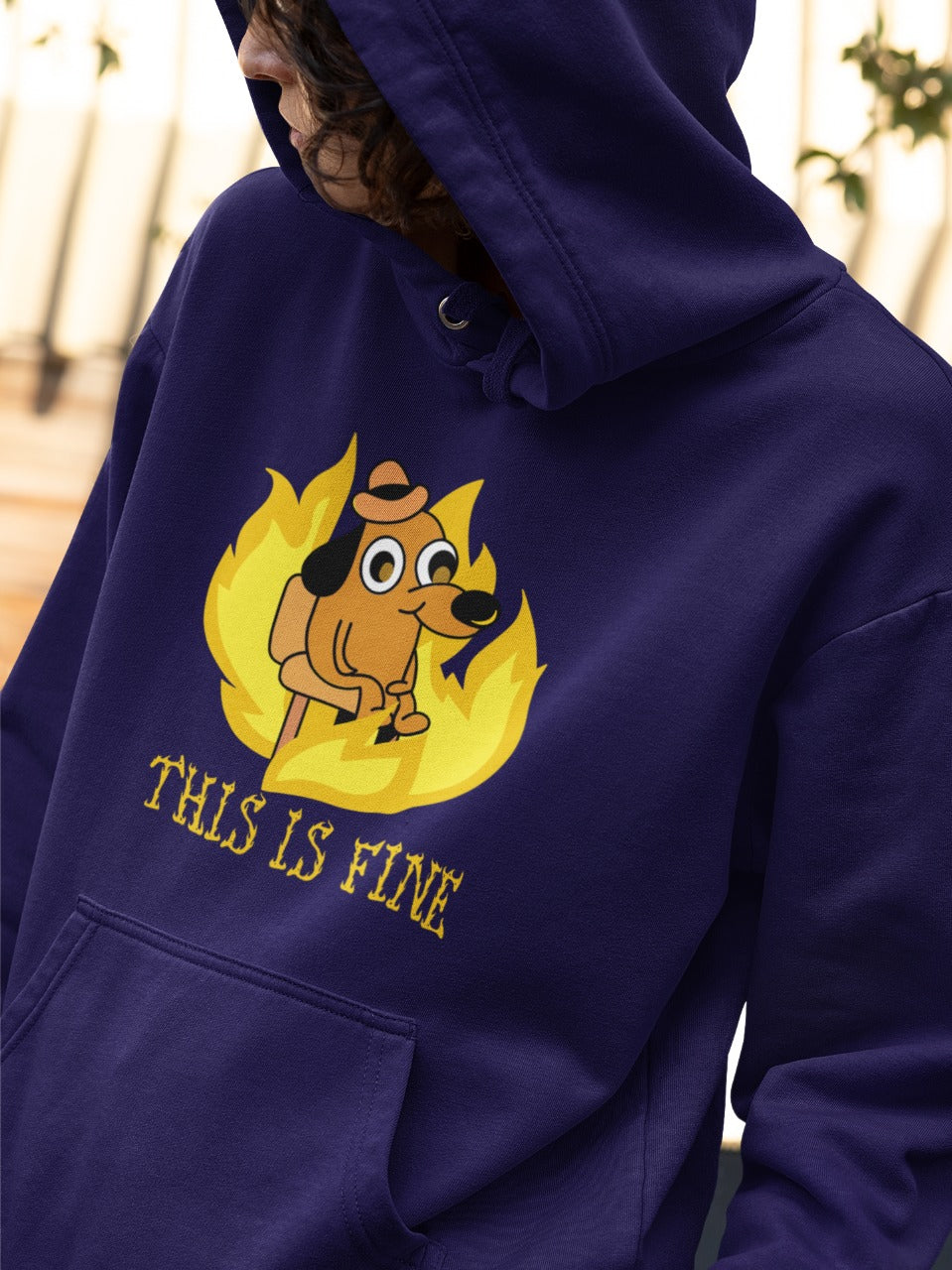 man wearing navy blue hoodie with a small dog sitting around a fire printed on it, "this is fine" in burning letter is printed below the dog, relatable sarcastic funny memes