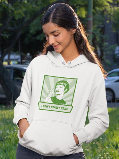 girl wearing a white hoodie with antique style illustration of woman talking on a phone saying I don't really care printed on it in green monochrome, relatable sarcastic memes