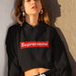 girl with huge round earrings wearing a black crop hoodie with suprememe printed on it in red colour