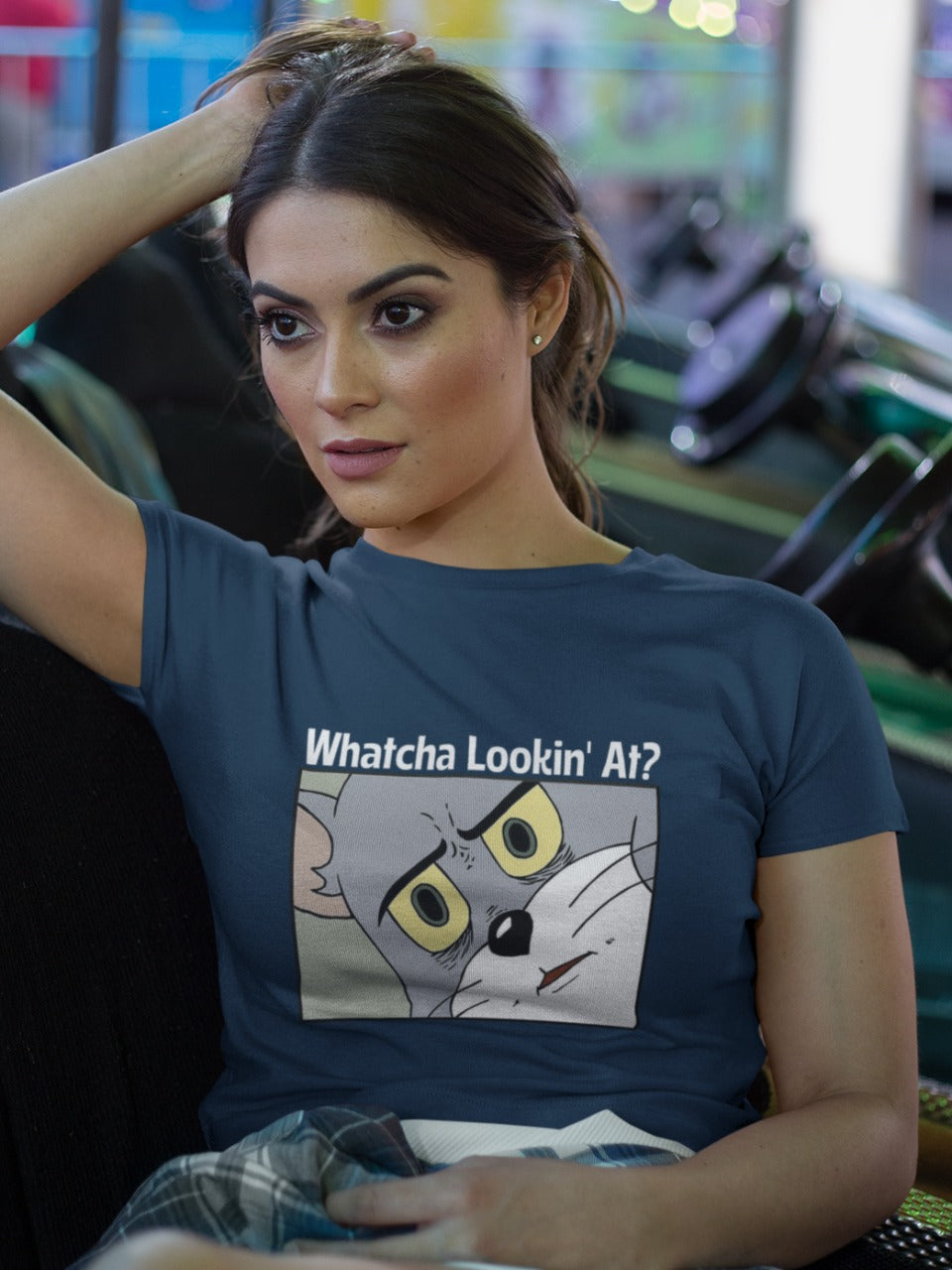 Girl wearing blue crop top with tomcat looking with judging and suspicious emotion and asking whatcha lookin' at? printed on it, sarcastic memes