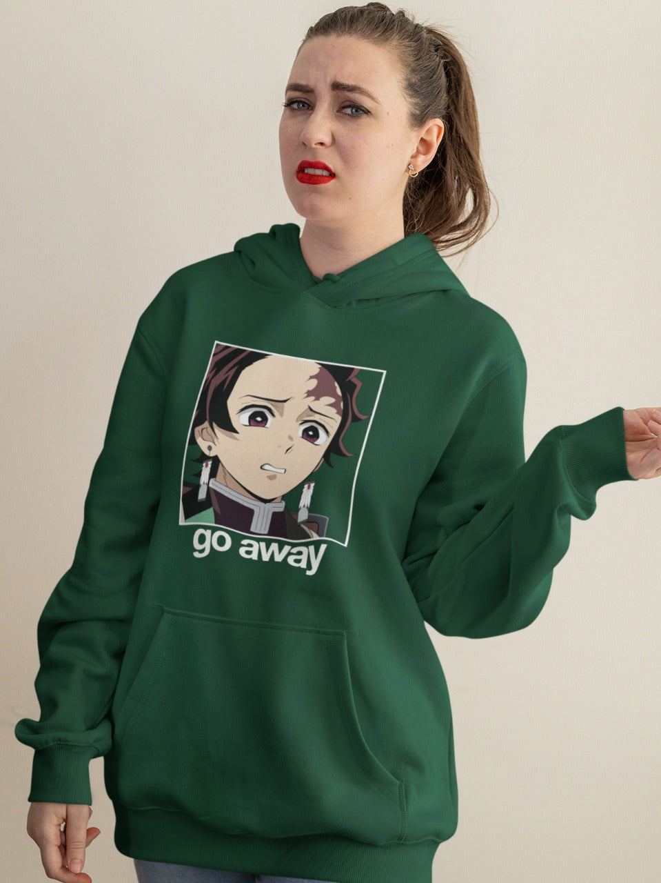 woman wearing olive-green hoodie with face of disgusted Tanjiro saying go away printed on it, sarcastic funny anime memes