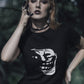 girl with black paint on her fingers and a lip ring and nose ring wearing a black tshirt with smiling troll face in dark silhouette printed on it in white colour, dark, sarcastic, gothic memes