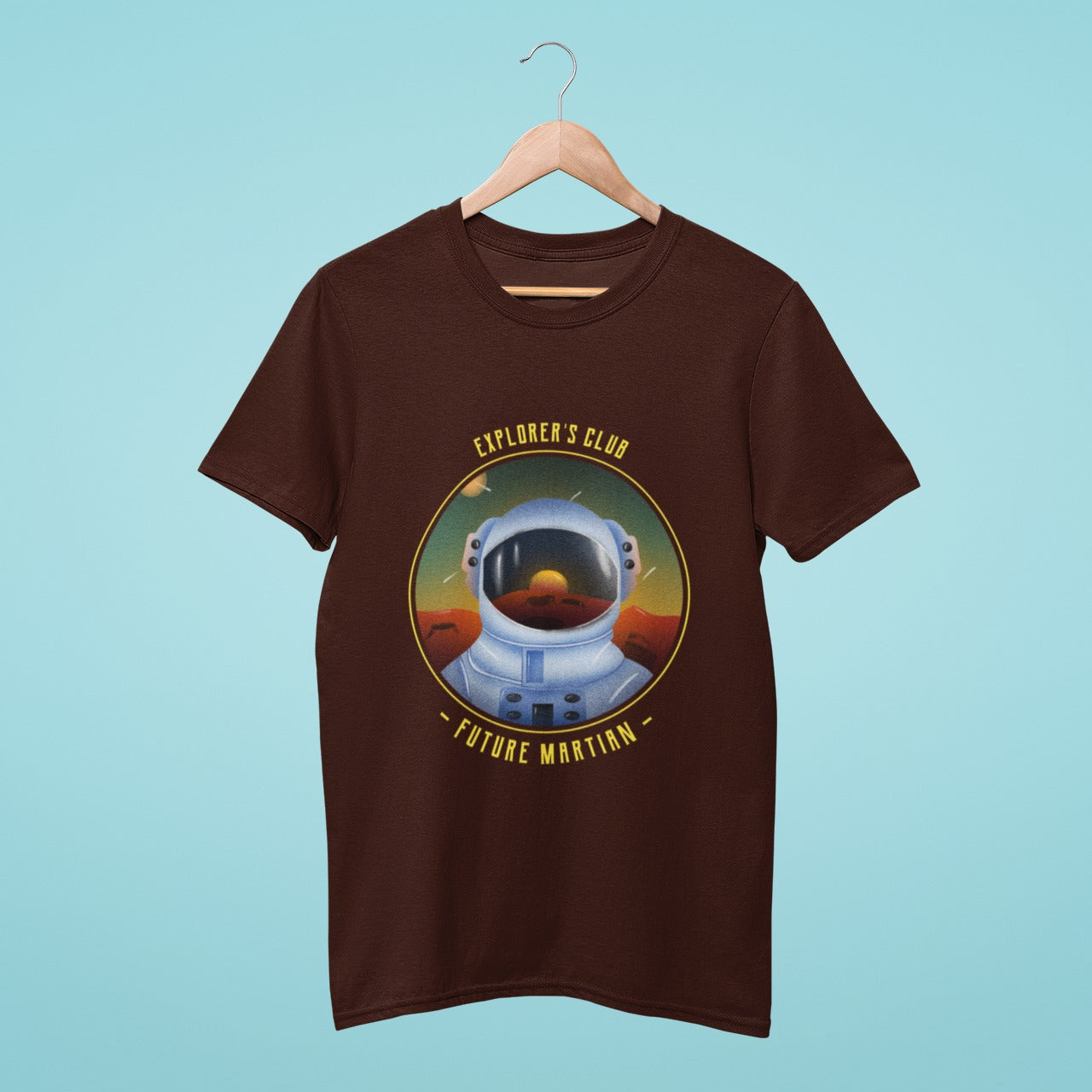 oin the Explorer's Club and gear up for the future Martian mission with this brown t-shirt. Featuring an astronaut in spacesuit on the Martian surface with a reflection of the rising sun, this shirt is the perfect addition to your space-themed wardrobe.