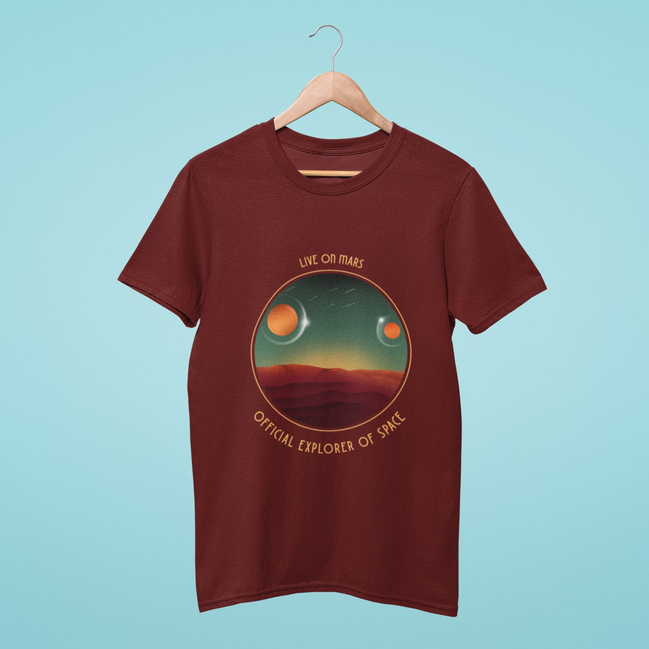 Be an official explorer of space with this brown t-shirt featuring the slogan 'Live on Mars' and a graphic of the Martian land with two moons. Perfect for anyone who dreams of space exploration and adventure. Get yours today and show your support for the exploration of our solar system.