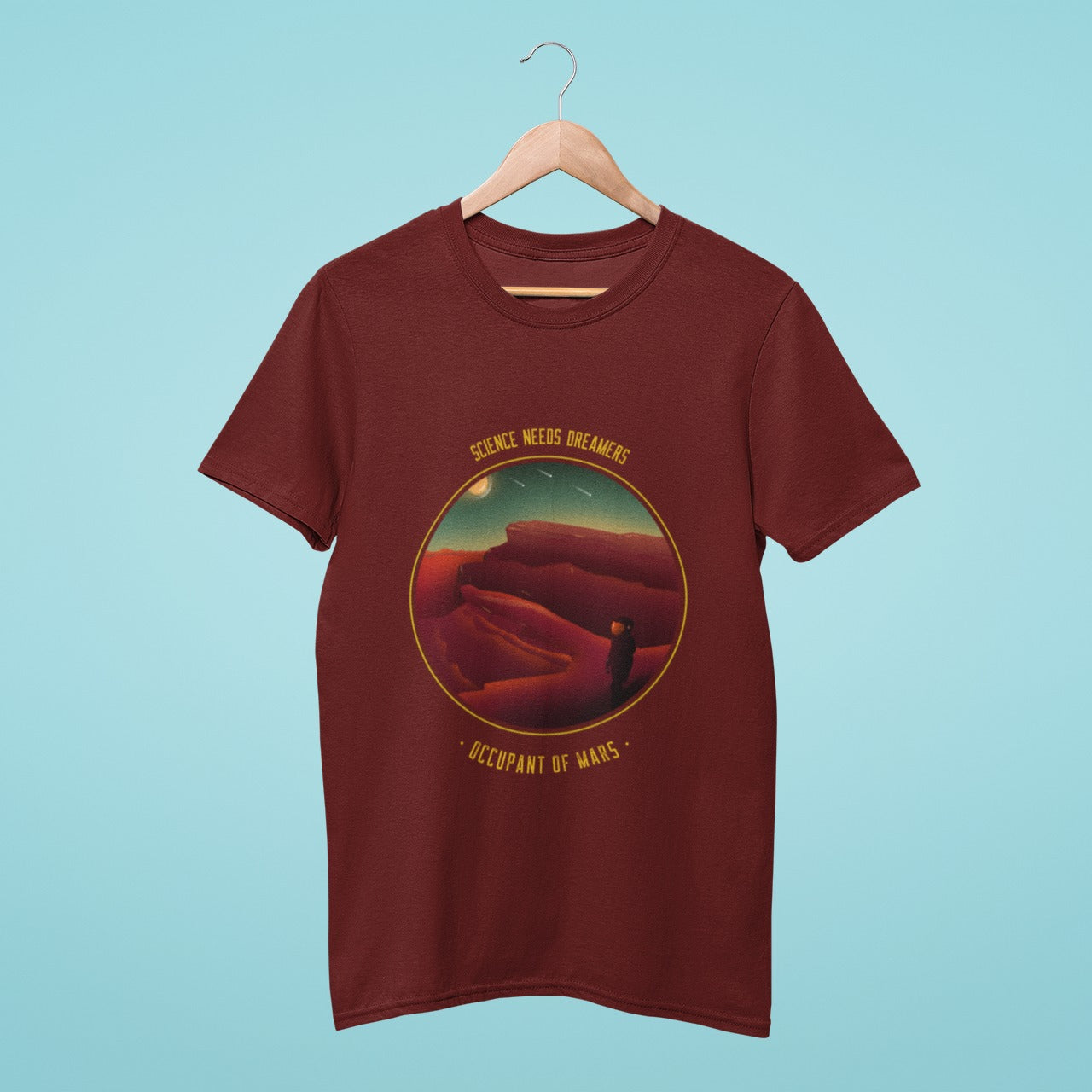Science needs dreamers" - this brown t-shirt with an occupant of Mars graphic and slogan is perfect for those who believe in pushing the boundaries of space exploration. Join the journey to the red planet and inspire others to dream big!
