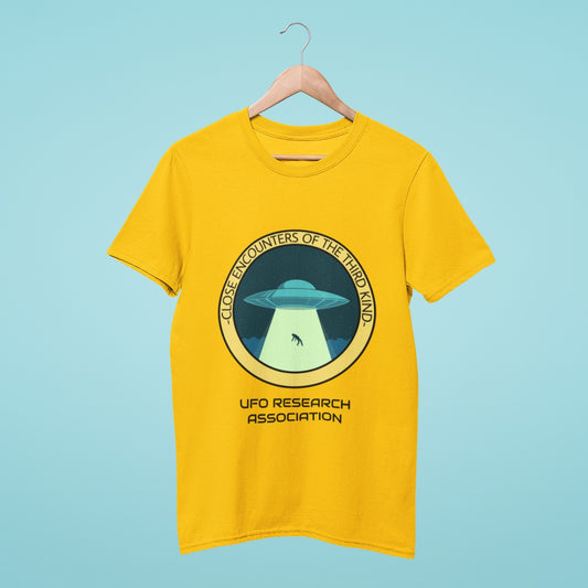 Elevate your wardrobe with our yellow t-shirt featuring a bold design of a UFO abducting a person, with the title "Close Encounters of the Third Kind - UFO Research Association". Perfect for UFO enthusiasts and those who love edgy fashion. Made from high-quality materials, this comfortable and durable t-shirt is a must-have. Order now and show off your out-of-this-world style!