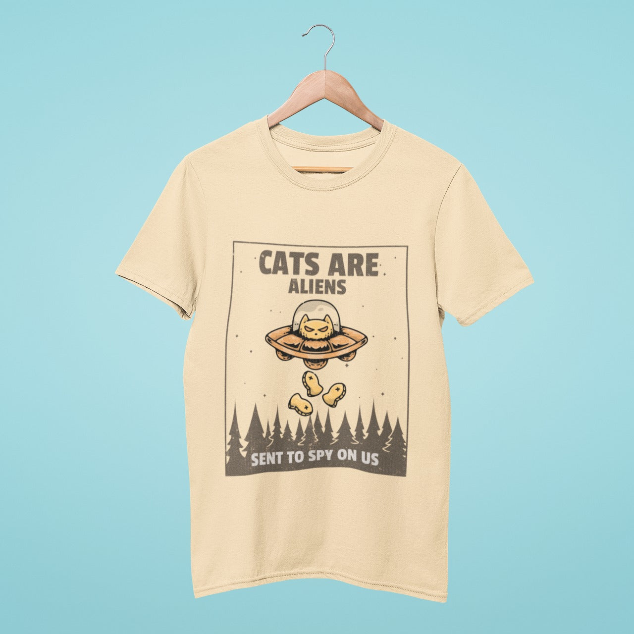 Add some quirky charm to your wardrobe with our beige t-shirt featuring a cute cat in a UFO with the slogan "Cats are aliens sent to spy on us". Perfect for cat lovers and anyone who loves unique, playful fashion. Made from high-quality materials, this comfortable and durable t-shirt is a must-have. Order now and let the conversation begin!