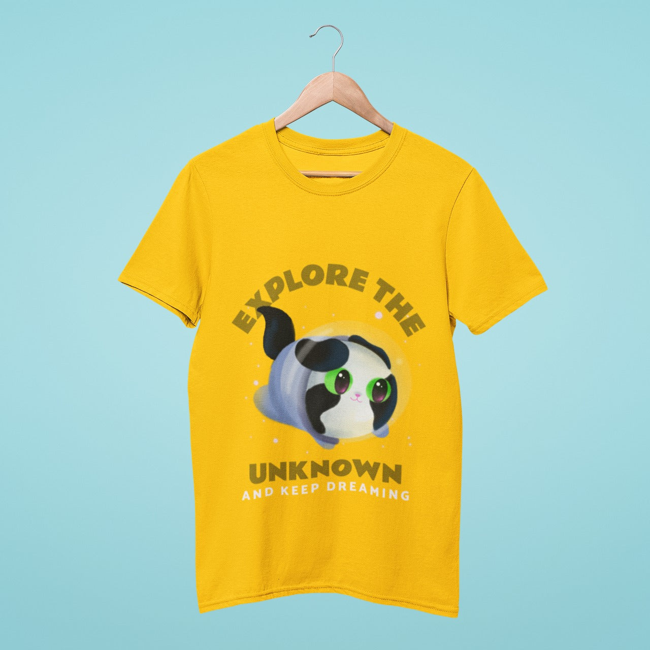 Get inspired with our yellow t-shirt featuring an adorable, wide-eyed kitten and the slogan "Explore the Unknown and Keep Dreaming". Made from high-quality materials, this unique design is perfect for casual outings or as a gift. Add some positivity to your wardrobe and get our yellow t-shirt with cute kitten and inspiring slogan today!