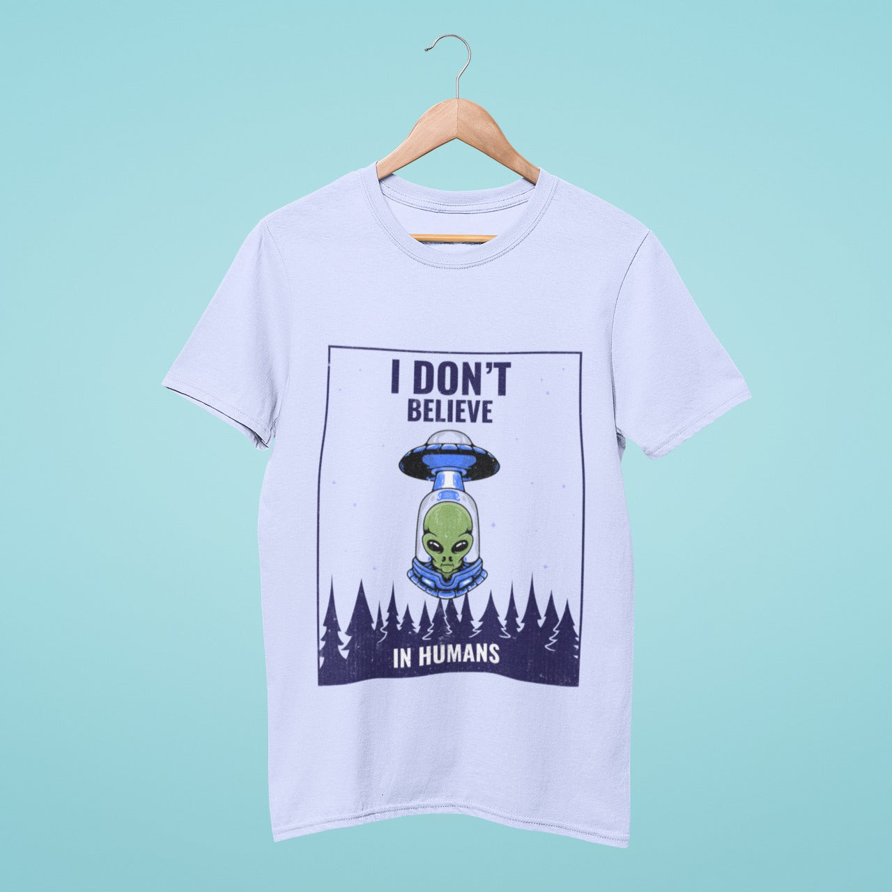 Get the ultimate extraterrestrial statement t-shirt. Light blue with a UFO and alien design and "I Don't Believe in Humans" quote. Comfortable, high-quality and perfect for alien enthusiasts. Showcase your love for the unknown. Order now!