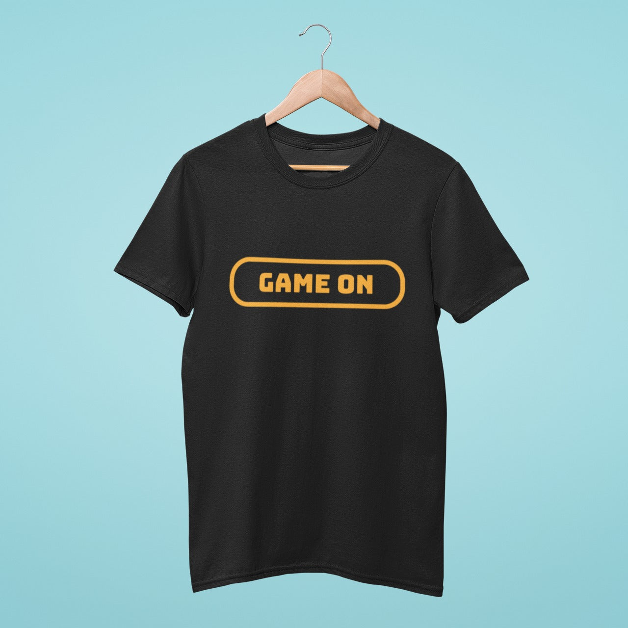 Get your game on with our stylish black t-shirt featuring "Game On" written in orange gaming button style. Made with high-quality materials, this comfortable and durable t-shirt is perfect for everyday wear or gaming events. Show off your love for gaming with our Game On t-shirt. Order yours today and level up your wardrobe!
