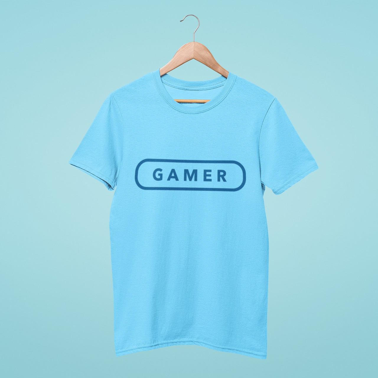 Game On! This navy blue t-shirt featuring 'Gamer' in a game button style is perfect for any gaming enthusiast. With its comfortable fit and stylish design, it's the perfect addition to your gaming wardrobe. Get ready to level up your style game with this trendy tee!