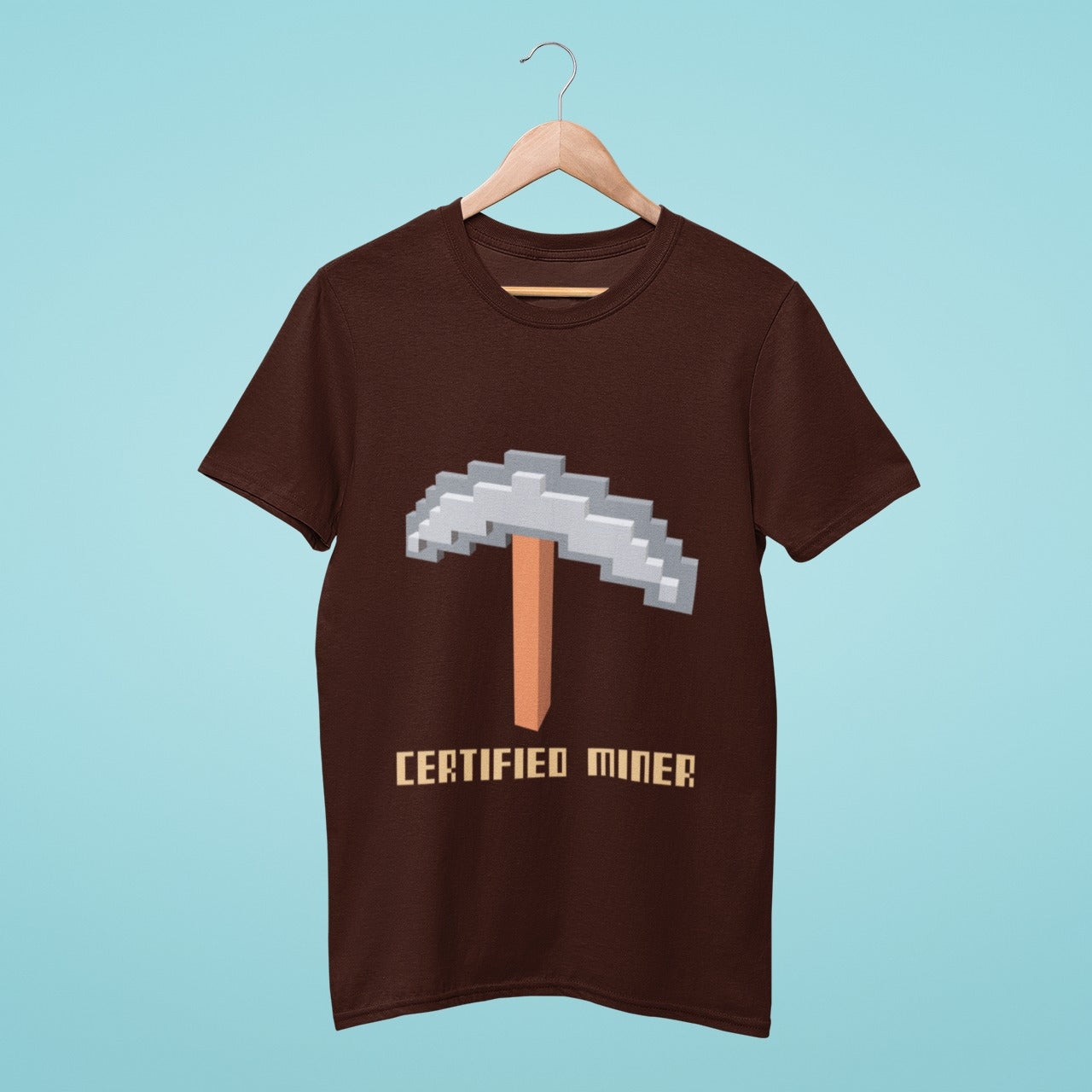 Show off your love for Minecraft with our official miner t-shirt! Featuring a Minecraft-style pickaxe graphic on a brown background, this t-shirt is perfect for any true fan. Wear it while mining and crafting in-game or just lounging around at home.