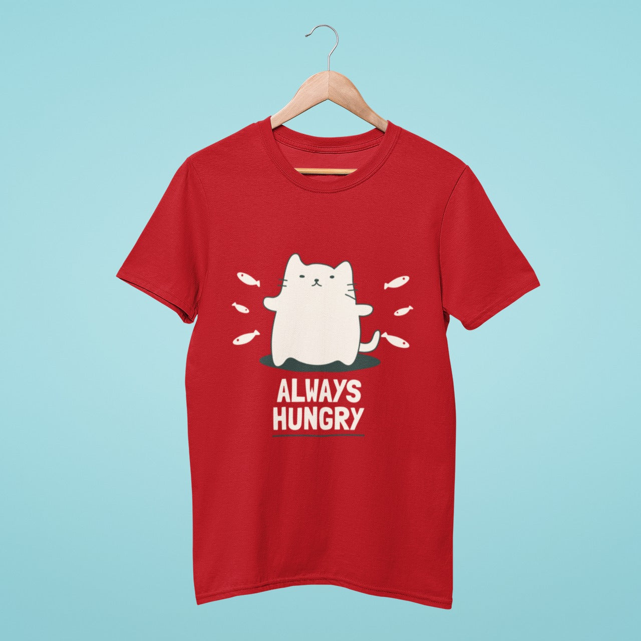 Satisfy your love for cats and food with our red t-shirt featuring a chubby cat surrounded by fish and the fun slogan "Always hungry". Made from high-quality materials, this comfortable and durable tee is perfect for everyday wear. Don't miss out on adding this adorable and relatable shirt to your collection!