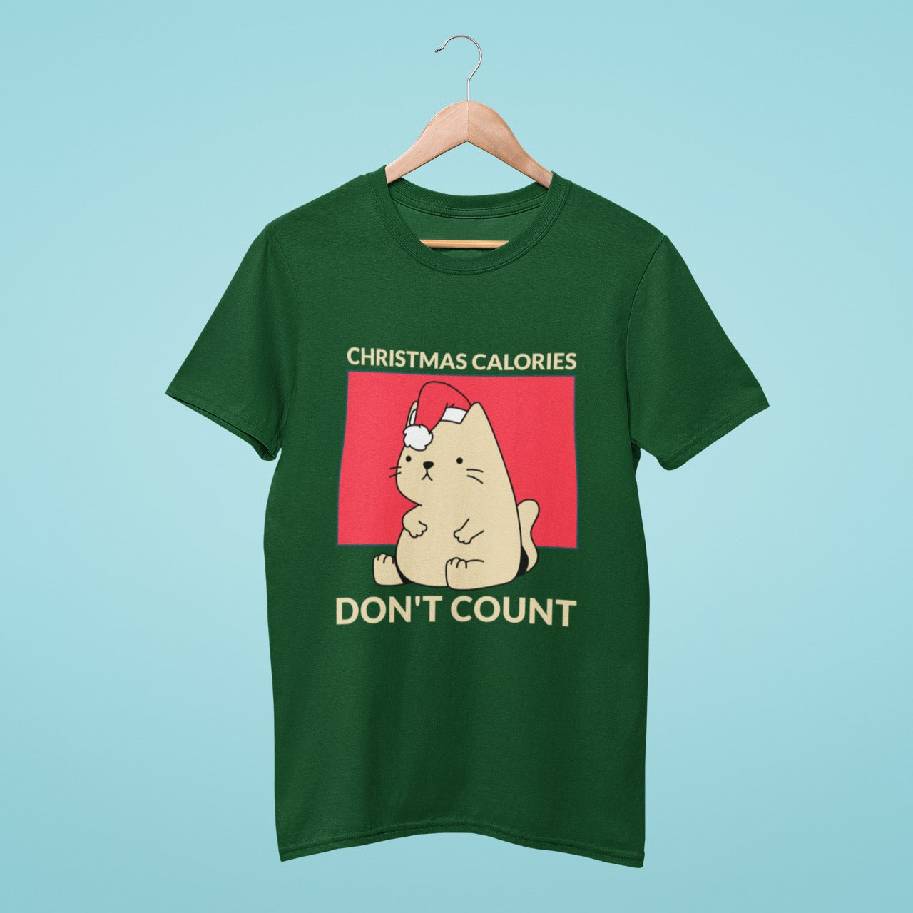 Celebrate the holidays in style with our green t-shirt featuring a cute and chubby cat wearing a Christmas hat and the fun slogan "Christmas calories don't count". Made from high-quality materials, this comfortable and durable shirt is perfect for festive events and gatherings. Don't miss out on adding this must-have holiday tee to your wardrobe!