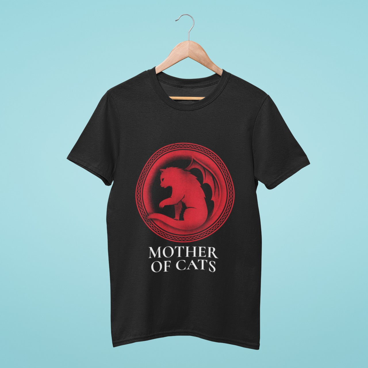 Our black "Mother of Cats" t-shirt is a must-have for cat lovers! Featuring a circular design of a red-colored cat with dragon wings resembling the Game of Thrones logo, this high-quality cotton t-shirt is perfect for any casual occasion.